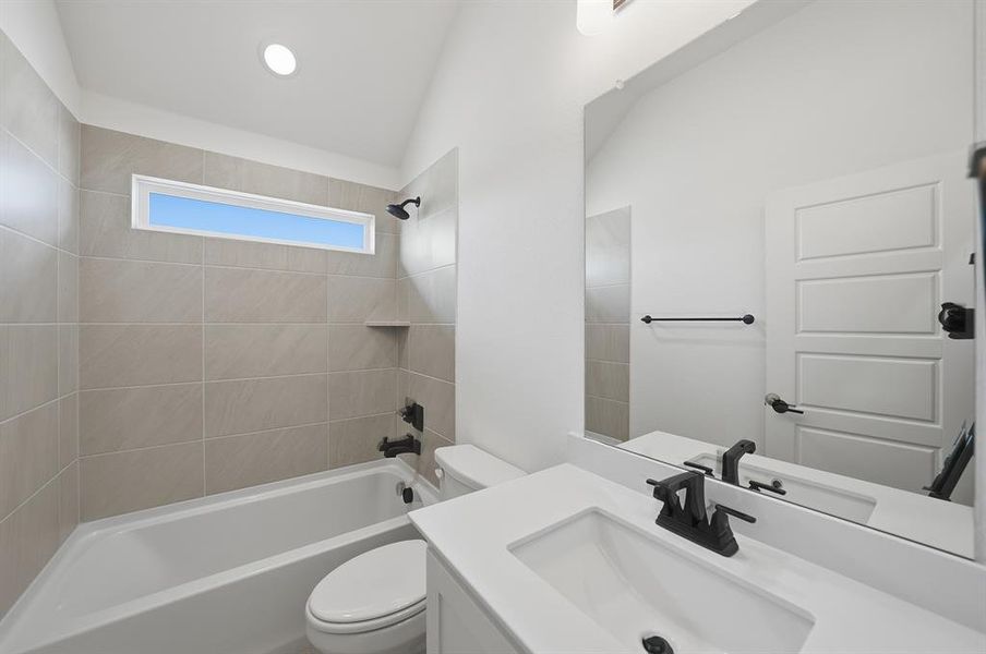 Full bathroom featuring washtub / shower combination, vanity, vaulted ceiling, and recessed lighting Full bathroom featuring washtub / shower combination, vanity, vaulted ceiling, and recessed lighting