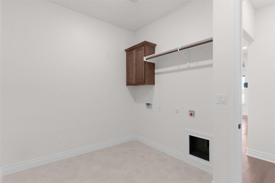 Laundry room with gas dryer hookup, cabinet space, and hookup for a washing machine