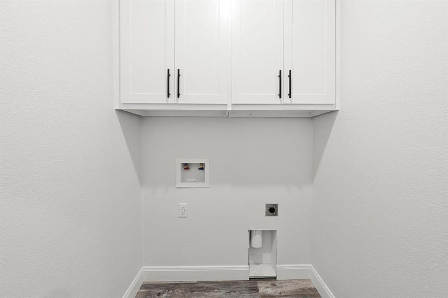 Laundry area with electric dryer hookup, cabinet space, washer hookup, and wood finished floors Laundry area with electric dryer hookup, cabinet space, washer hookup, and wood finished floors