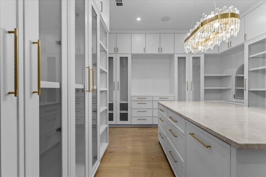 Primary Walk in closet with built ins and vanity