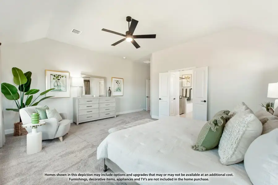 Spacious master bedroom with vaulted ceiling, ceiling fan, carpet flooring, and ensuite bathroom doorway