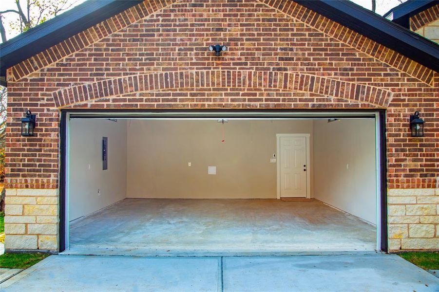 Garage featuring concrete driveway