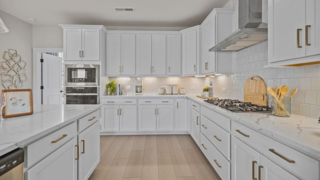 The Stonefield Home Plan by DRB Homes in Belmont, NC. - Kitchen featuring an oversized bar and butler's panty
