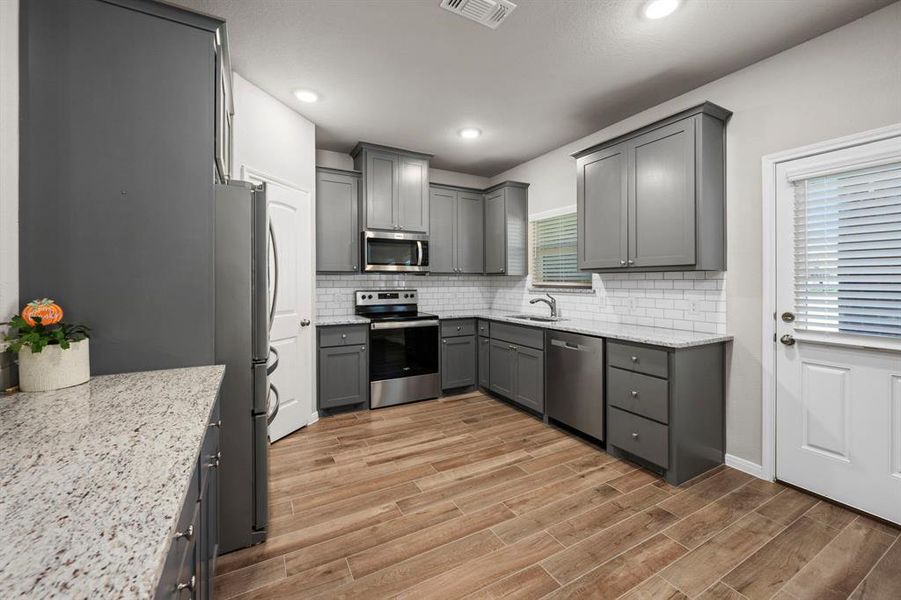 Beauty and function combine is this large,sleek,light and bright kitchen. Beautiful cabinets and brushed nickel hardware compliment the stainless steel appliances. Abundant counter space, cabinets and drawers. Room to store all your culinary tools.