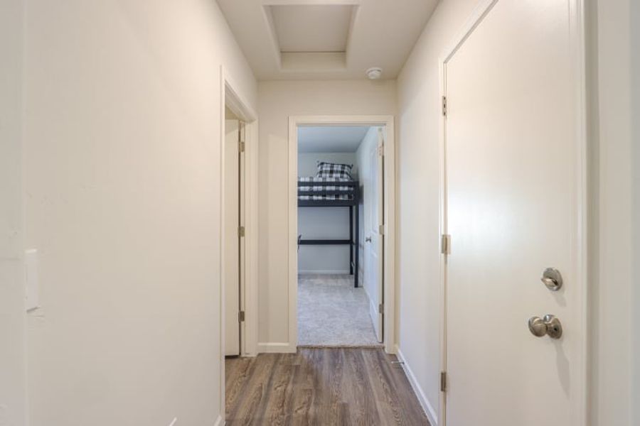 A hallway with white doors.
