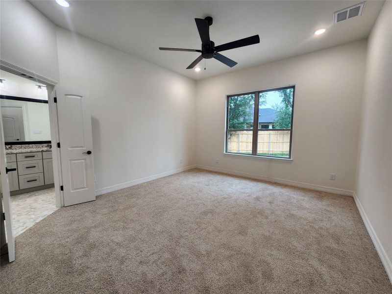 Spacious room featuring carpet flooring, recessed lighting, and a contemporary black ceiling fan