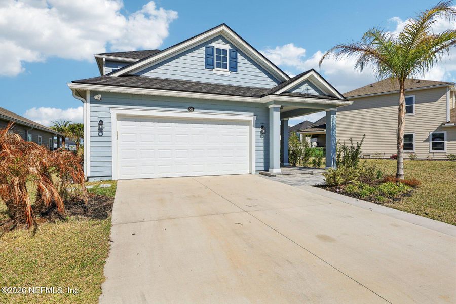 Front exterior of a new home in Beacon Lake, St. Augustine, FL, highlighting curb appeal (Image 27).