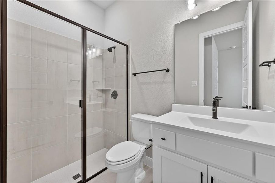 Contemporary bathroom featuring a framed glass shower enclosure, white subway tile shower surround, and a built-in shower shelf Contemporary bathroom featuring a framed glass shower enclosure, white subway tile shower surround, and a built-in shower shelf
