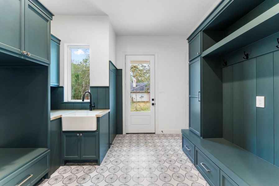 Combined laundry and mud room is conveniently located off the garage.