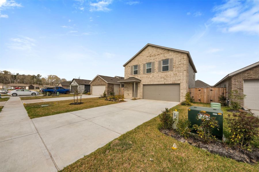 Front exterior of a new home in , New Caney, TX, highlighting curb appeal (Image 22).