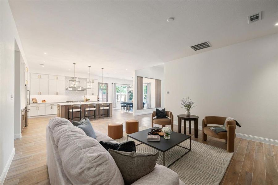 Living area featuring recessed lighting and light wood finished floors Living area featuring recessed lighting and light wood finished floors