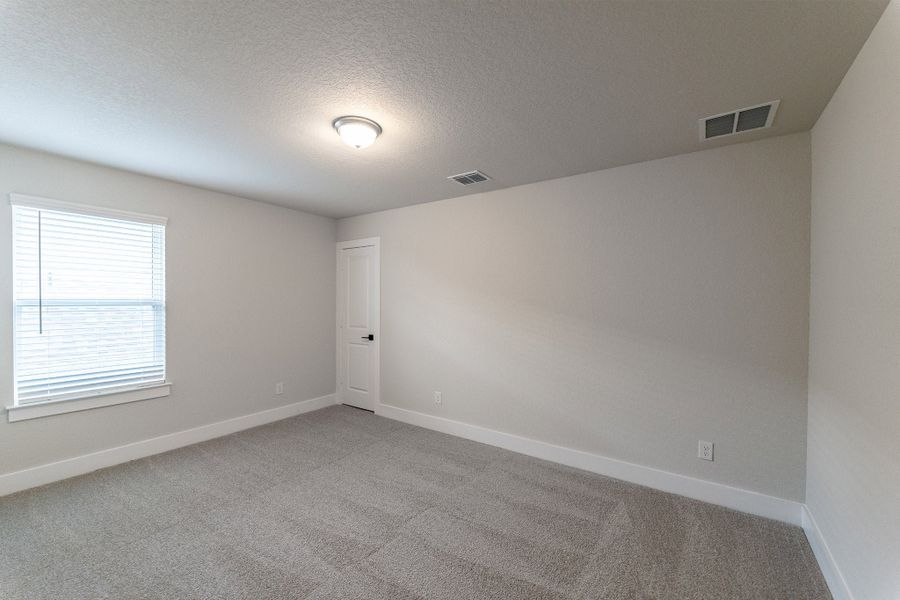 Spacious, unfurnished interior of a new home in The Woodlands at Medina Hills, Mico (Image 22).