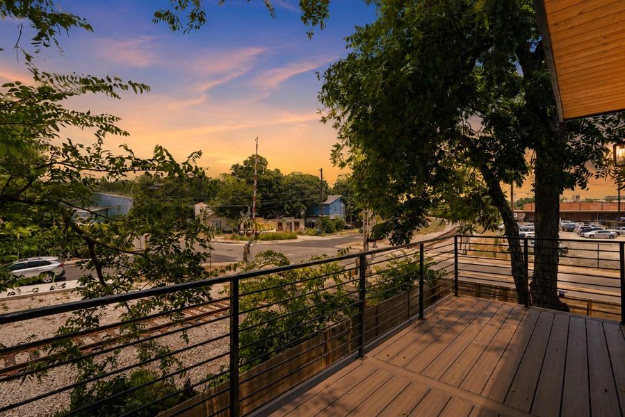 An inviting deck overlooks the neighborhood, offering a perfect spot to enjoy sunset skies.