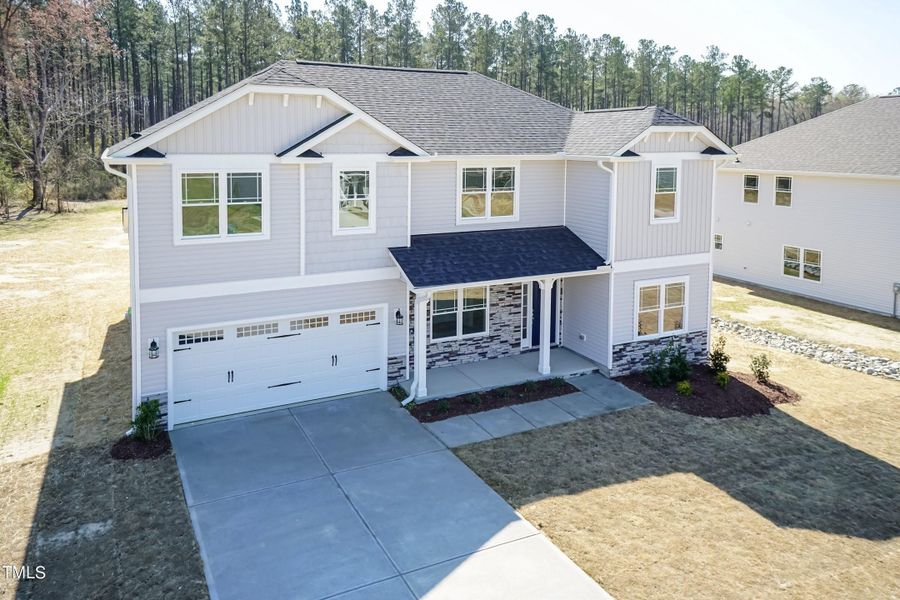 Front exterior of a new home in Falls of the Cape, Lillington, NC, highlighting curb appeal (Image 25).