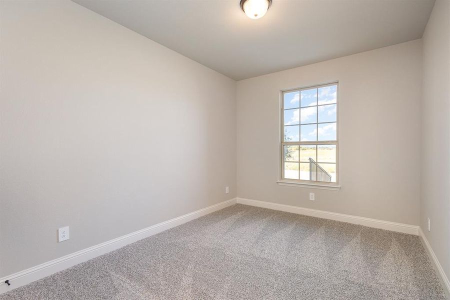 Spare room featuring carpet flooring