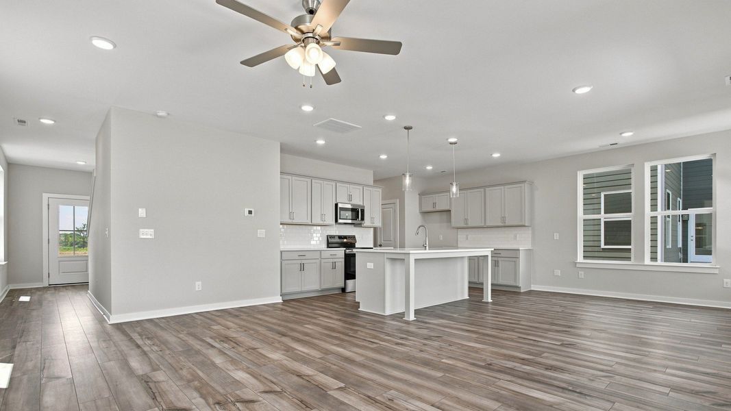 View of spacious kitchen from back windows with natural light highlighting elevated flooring View of spacious kitchen from back windows with natural light highlighting elevated flooring