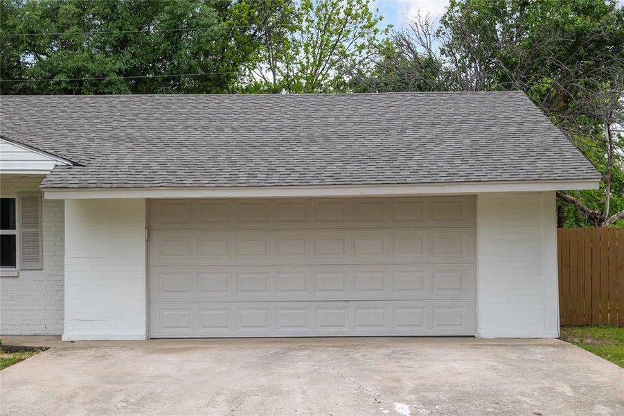 Garage with driveway and fence Garage with driveway and fence