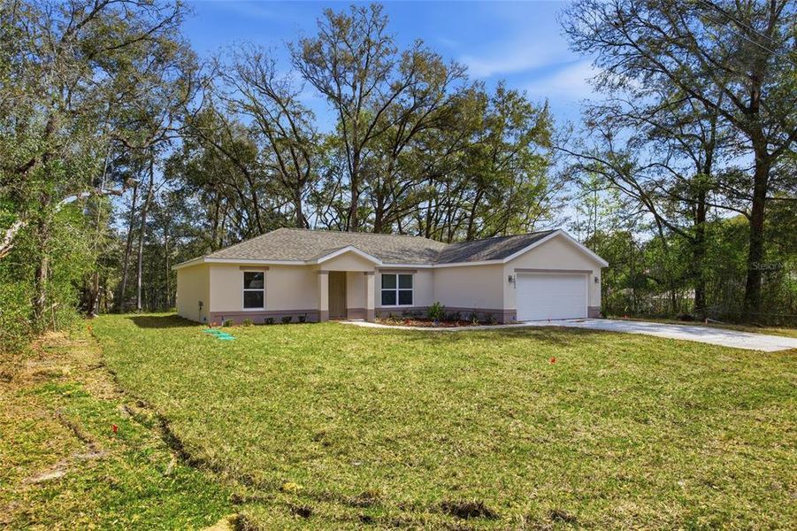Front exterior of a new home in , Summerfield, FL, highlighting curb appeal (Image 25).