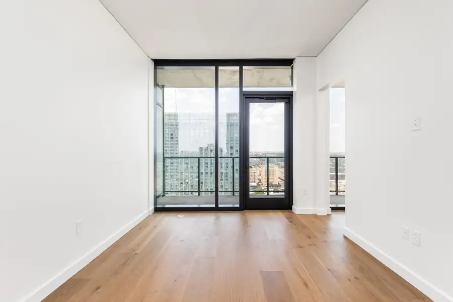 Floor-to-ceiling windows showcase captivating city views.