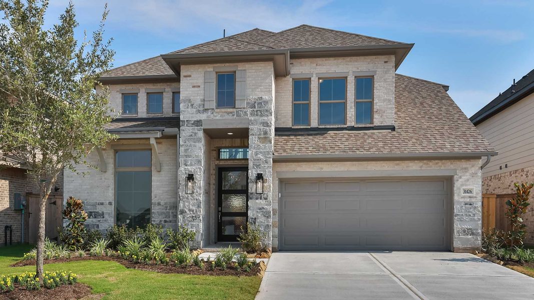 Front exterior of a new home in Jordan Ranch, Fulshear, TX, highlighting curb appeal (Image 1). Front exterior of a new home in Jordan Ranch, Fulshear, TX, highlighting curb appeal (Image 1).