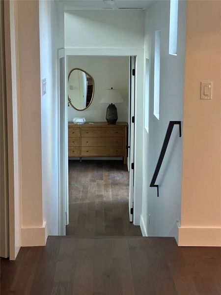 Corridor with dark wood finished floors and baseboards Corridor with dark wood finished floors and baseboards