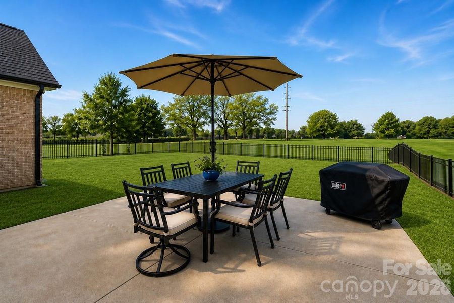 Open patio space with room for dining and grilling, ideal for enjoying the outdoors.