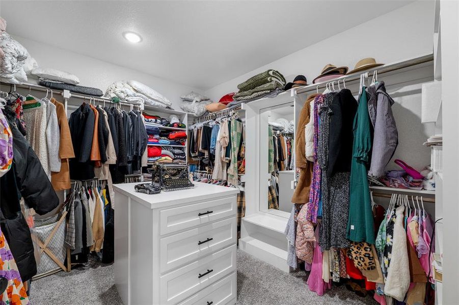 Walk in closet with light carpet