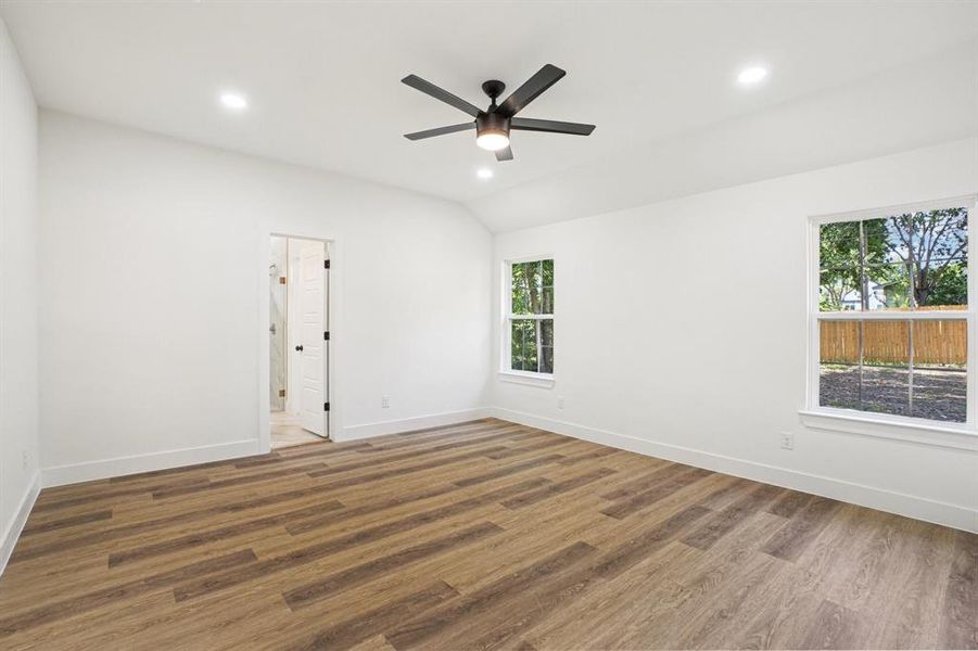 Spare room with recessed lighting, light wood-style flooring, and lofted ceiling Spare room with recessed lighting, light wood-style flooring, and lofted ceiling