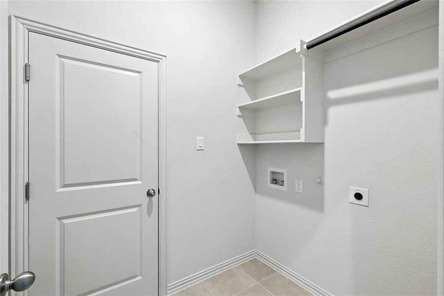 Laundry room with light tile patterned floors, electric dryer hookup, washer hookup, and gas dryer hookup Laundry room with light tile patterned floors, electric dryer hookup, washer hookup, and gas dryer hookup