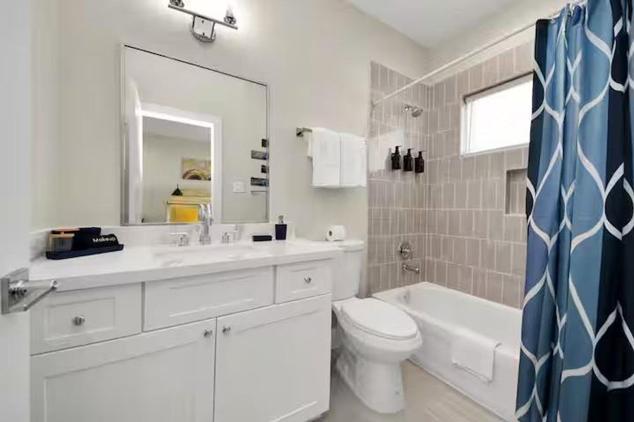 A full secondary bath with vanity storage and a tiled tub/shower combination keeps the upstairs layout practical for guests or additional occupants.