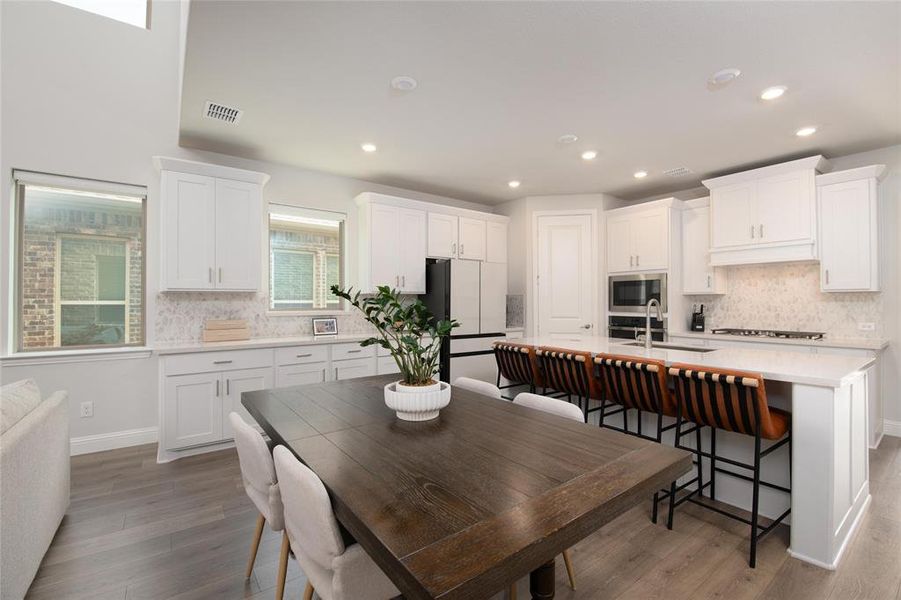 The spacious dining area is perfectly positioned between the kitchen and gathering room, creating a central hub for everyday meals, holiday celebrations, and memorable gatherings. The spacious dining area is perfectly positioned between the kitchen and gathering room, creating a central hub for everyday meals, holiday celebrations, and memorable gatherings.