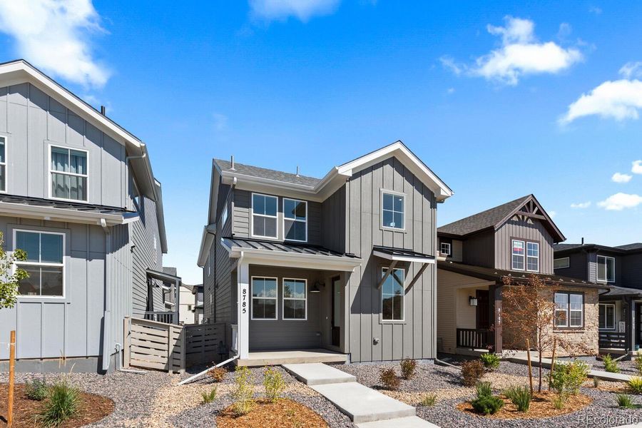 Front exterior of a new home in The Villas Collection at Sterling Ranch, Littleton, CO, highlighting curb appeal (Image 1).