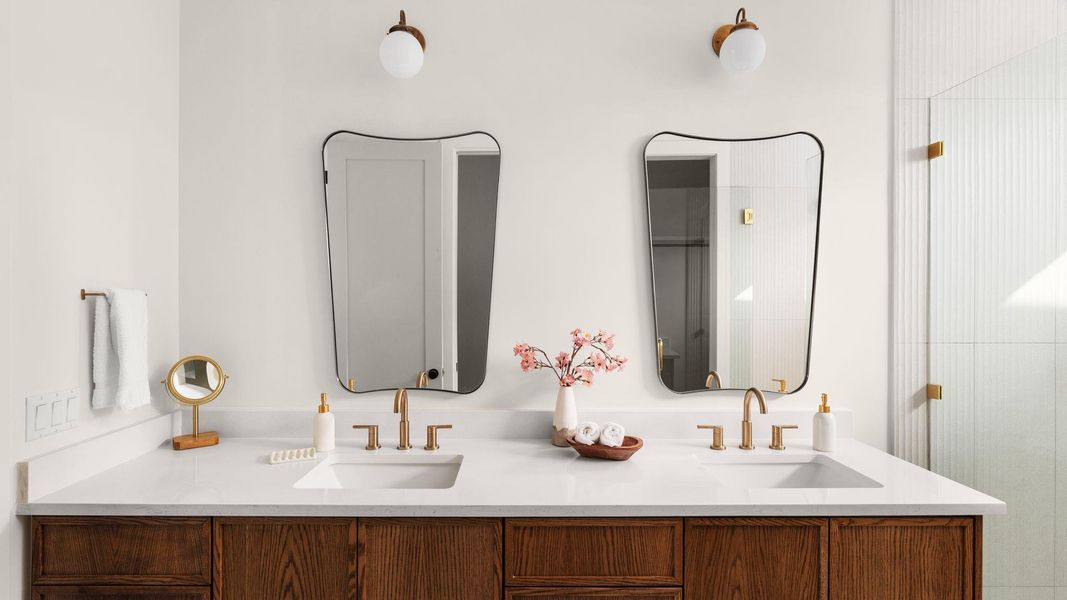 Full bath featuring double vanity and a shower with shower door