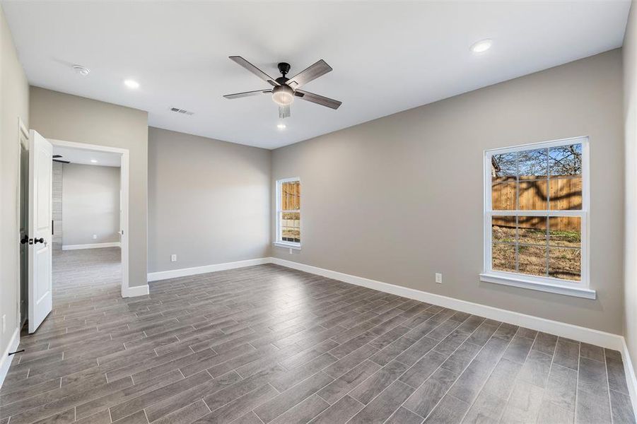 Unfurnished room with ceiling fan and hardwood / wood-style floors