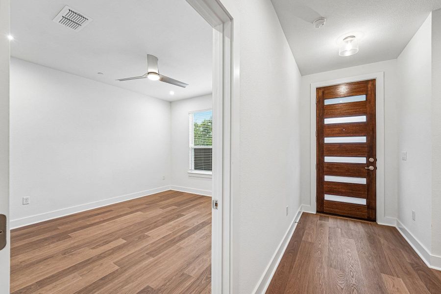 A modern front door, clean lines,and warm RevWood flooring give the lower level a simple, polishedfirst impression. A modern front door, clean lines,and warm RevWood flooring give the lower level a simple, polishedfirst impression.