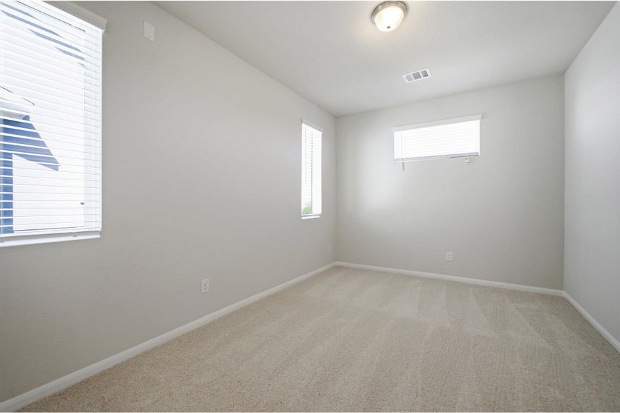 Empty room with light carpet and baseboards