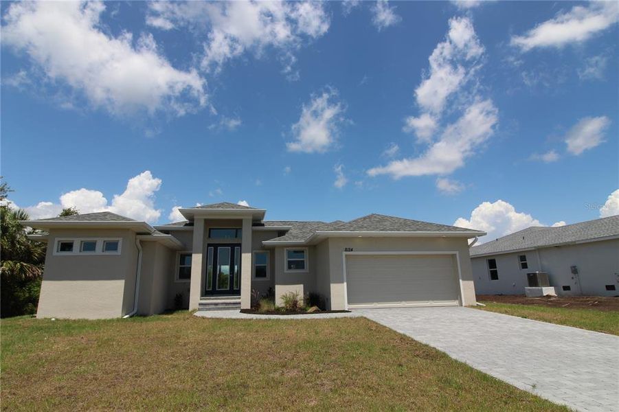 Front exterior of a new home in , Port Charlotte, FL, highlighting curb appeal (Image 2). Front exterior of a new home in , Port Charlotte, FL, highlighting curb appeal (Image 2).