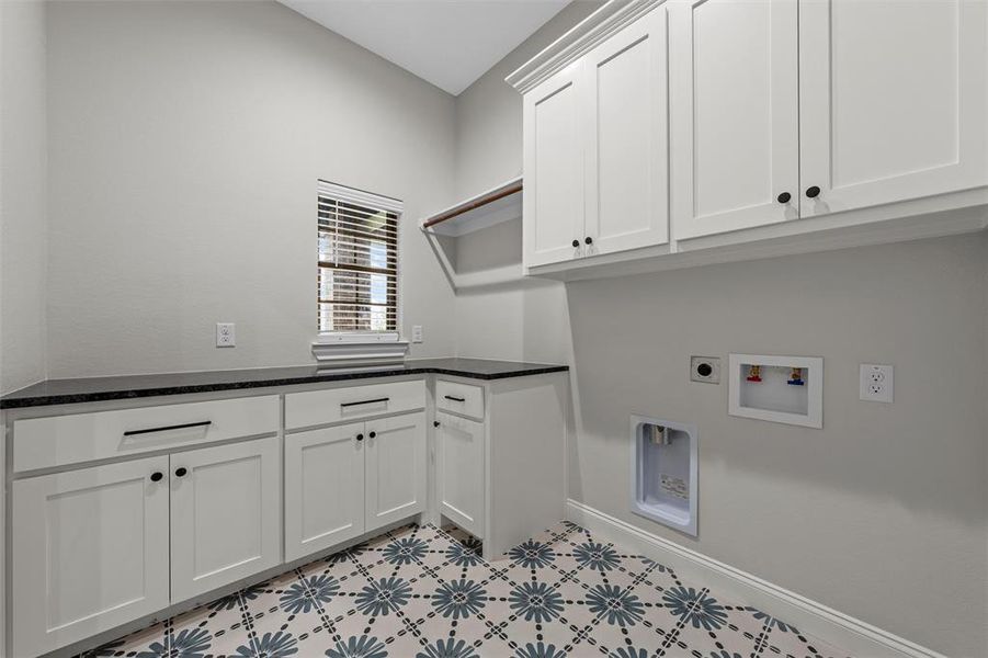 Laundry room with cabinet space, hookup for a washing machine, and electric dryer hookup Laundry room with cabinet space, hookup for a washing machine, and electric dryer hookup