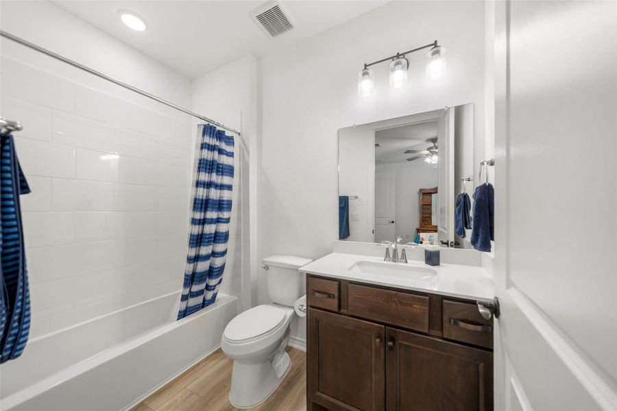 The extra full bath has Dekton (silestone) counters and combo tub/shower with tile surround.