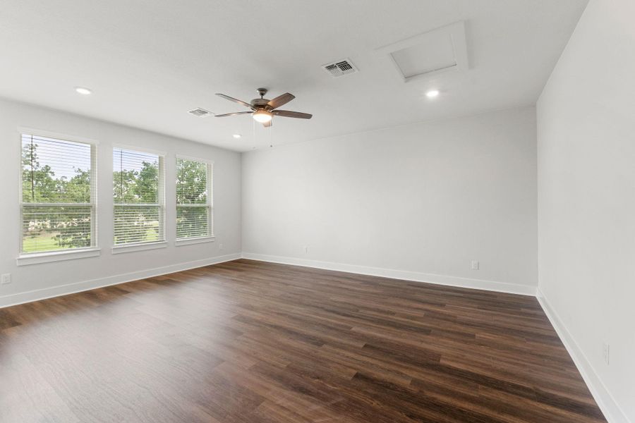 Unfurnished room with attic access, baseboards, dark wood finished floors, and recessed lighting Unfurnished room with attic access, baseboards, dark wood finished floors, and recessed lighting