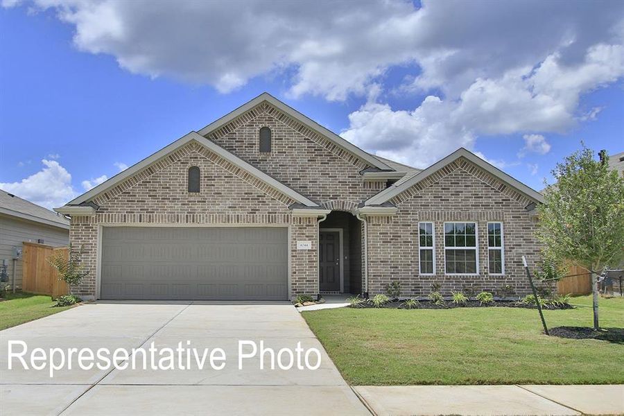 View of front of home featuring a front yard and a garage