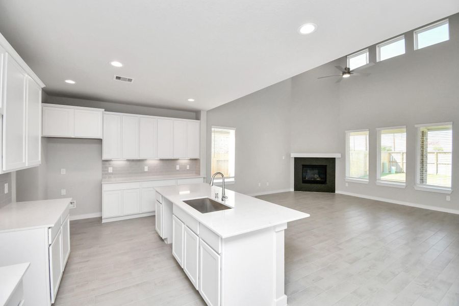 Discover another perspective of this stunning kitchen, generously appointed with an abundance of counter space. Sample photo of completed home with similar floor plan. Actual colors and selections may vary.