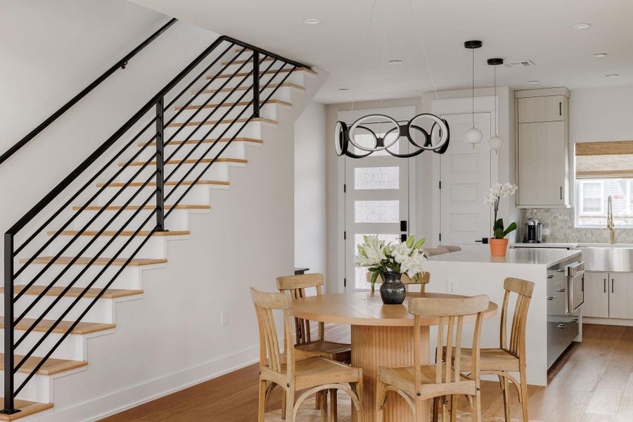 Dining room with stairway and light wood-style flooring
