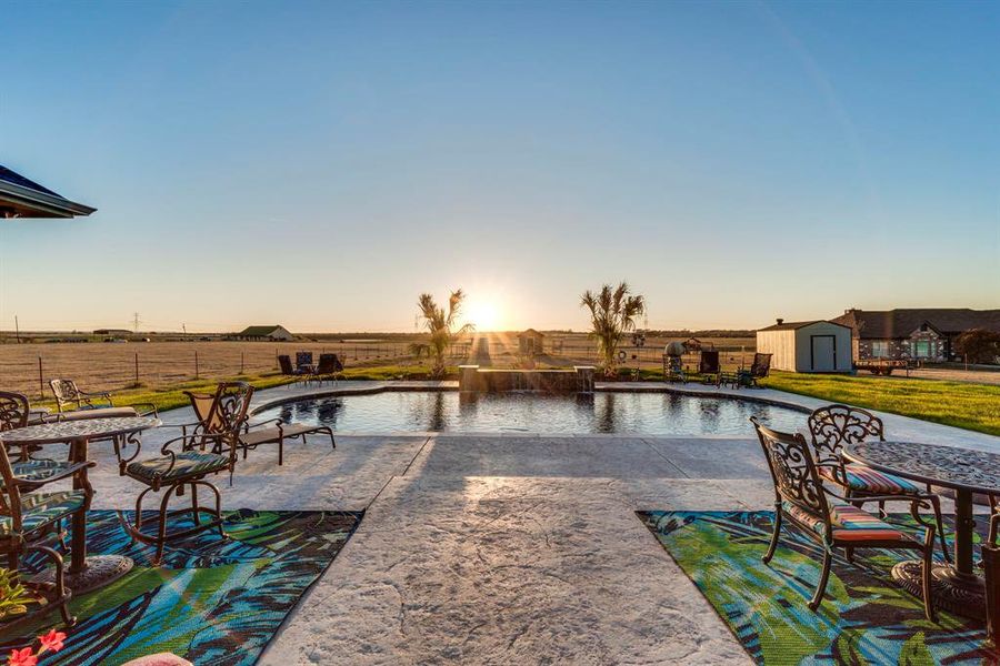 View of saltwater pool and a patio area, and a storage unit