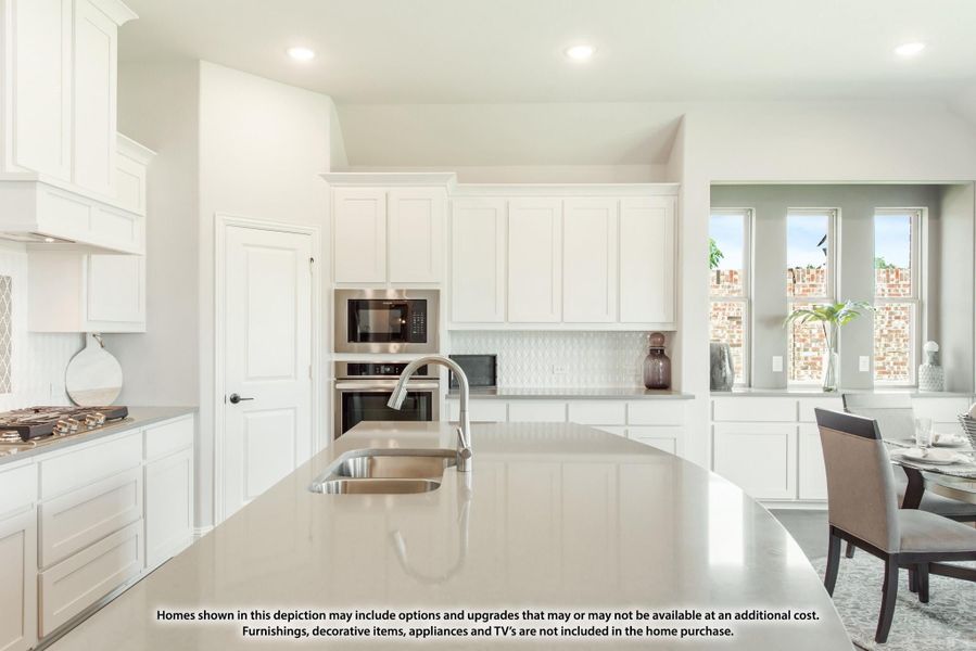 Kitchen with white cabinets, large island with sink, stainless steel appliances, and patterned tile backsplash