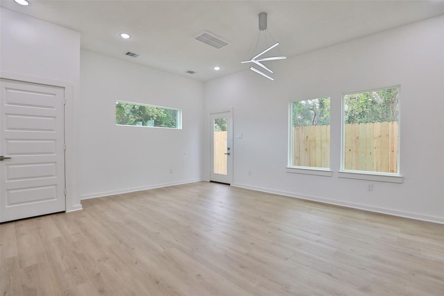 Bright and airy living room with abundant natural light. Back door leads to the fenced backyard. Bright and airy living room with abundant natural light. Back door leads to the fenced backyard.