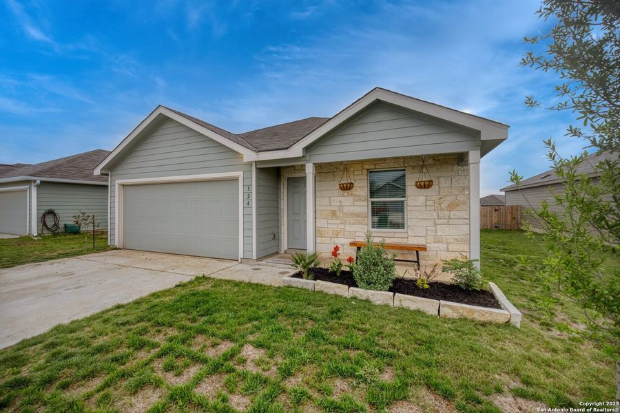 Front exterior of a new home in Guadalupe Heights: Watermill Collection, Seguin, TX, highlighting curb appeal (Image 18). Front exterior of a new home in Guadalupe Heights: Watermill Collection, Seguin, TX, highlighting curb appeal (Image 18).