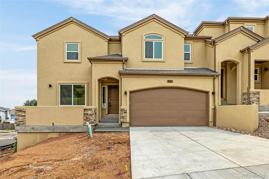 Front exterior of a new home in , Colorado Springs, CO, highlighting curb appeal (Image 1).
