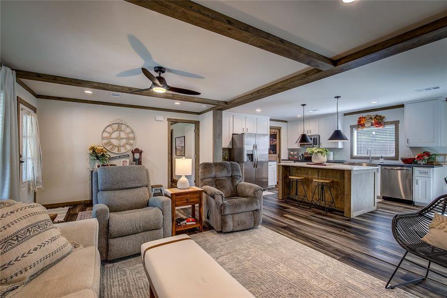 Living room with view of kitchen with island/breakfast bar