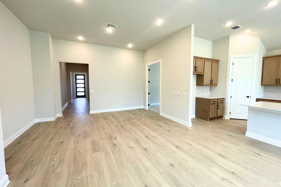 Smooth wood floors flow seamlessly through this open, well-lit living area. Smooth wood floors flow seamlessly through this open, well-lit living area.